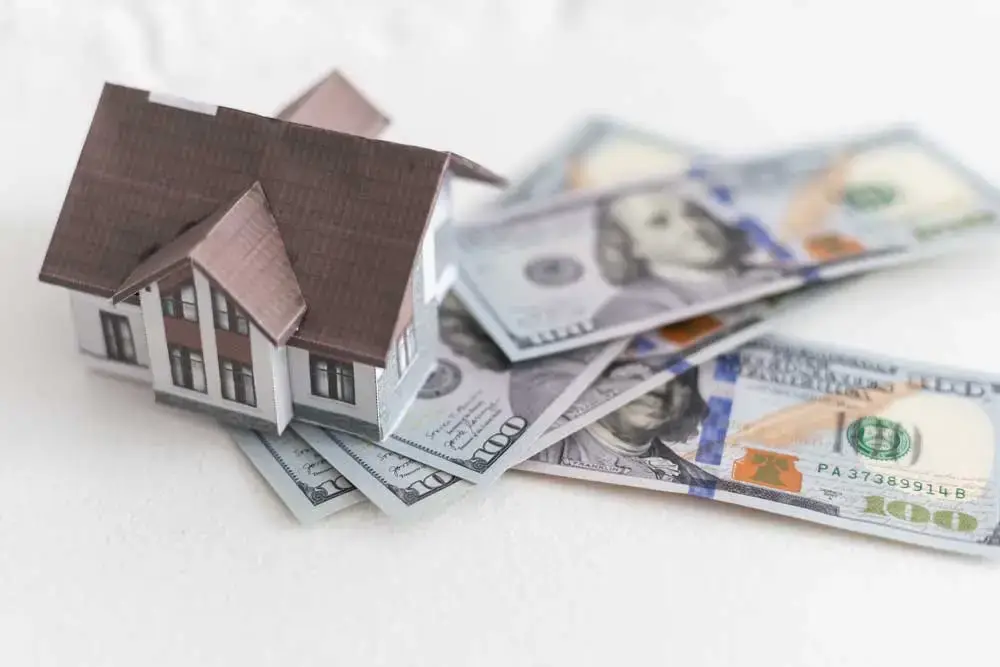 home sitting on a pile of money to demonstrate home equity